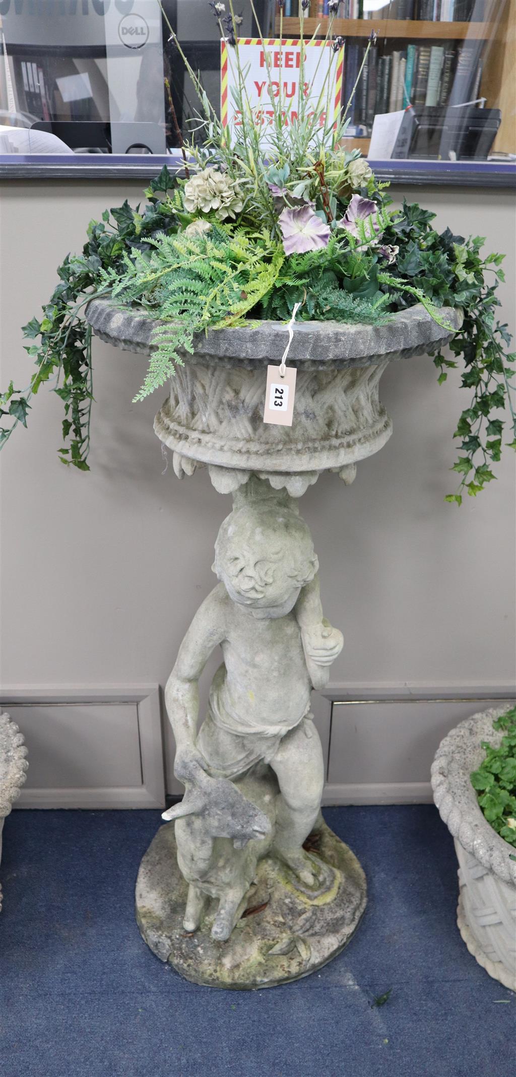 A reconstituted stone putto garden planter, height 123cm